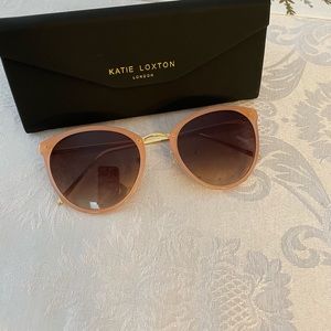 Katie Loxton light pink and gold trim sunglasses.